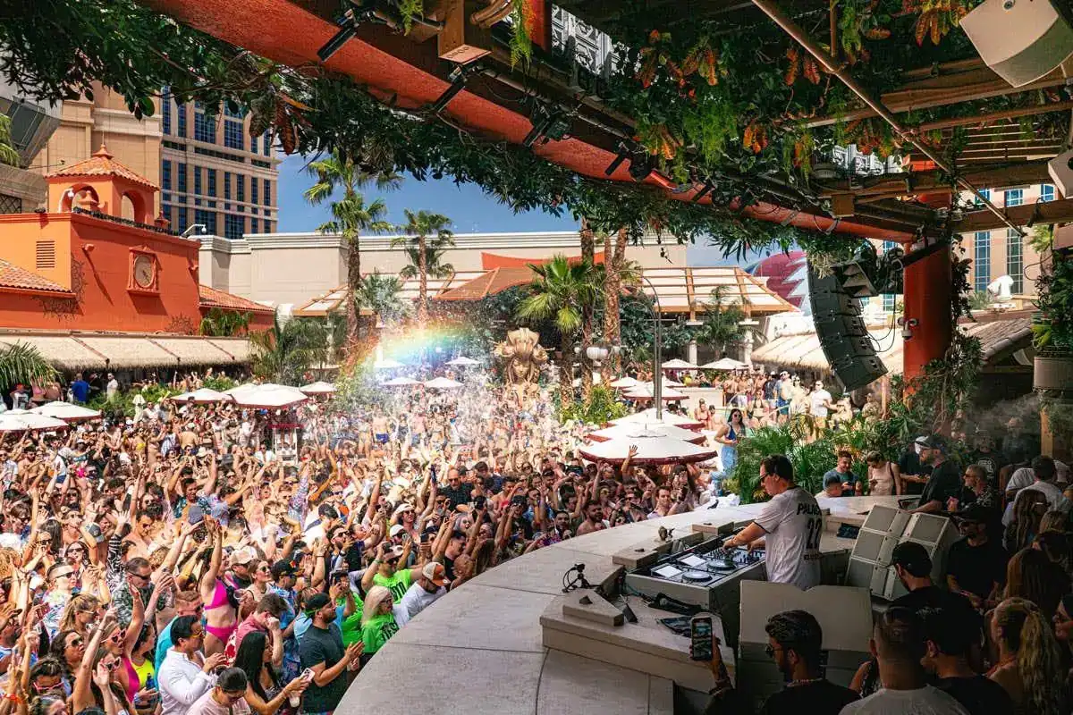 Tiësto performing from the TAO Beach DJ booth before a daytime crowd at The Venetian Resort Las Vegas.